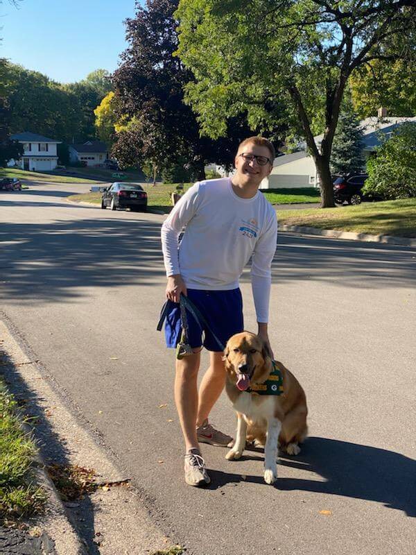 Twin Cities Pain Clinic employee posing on the street with dog