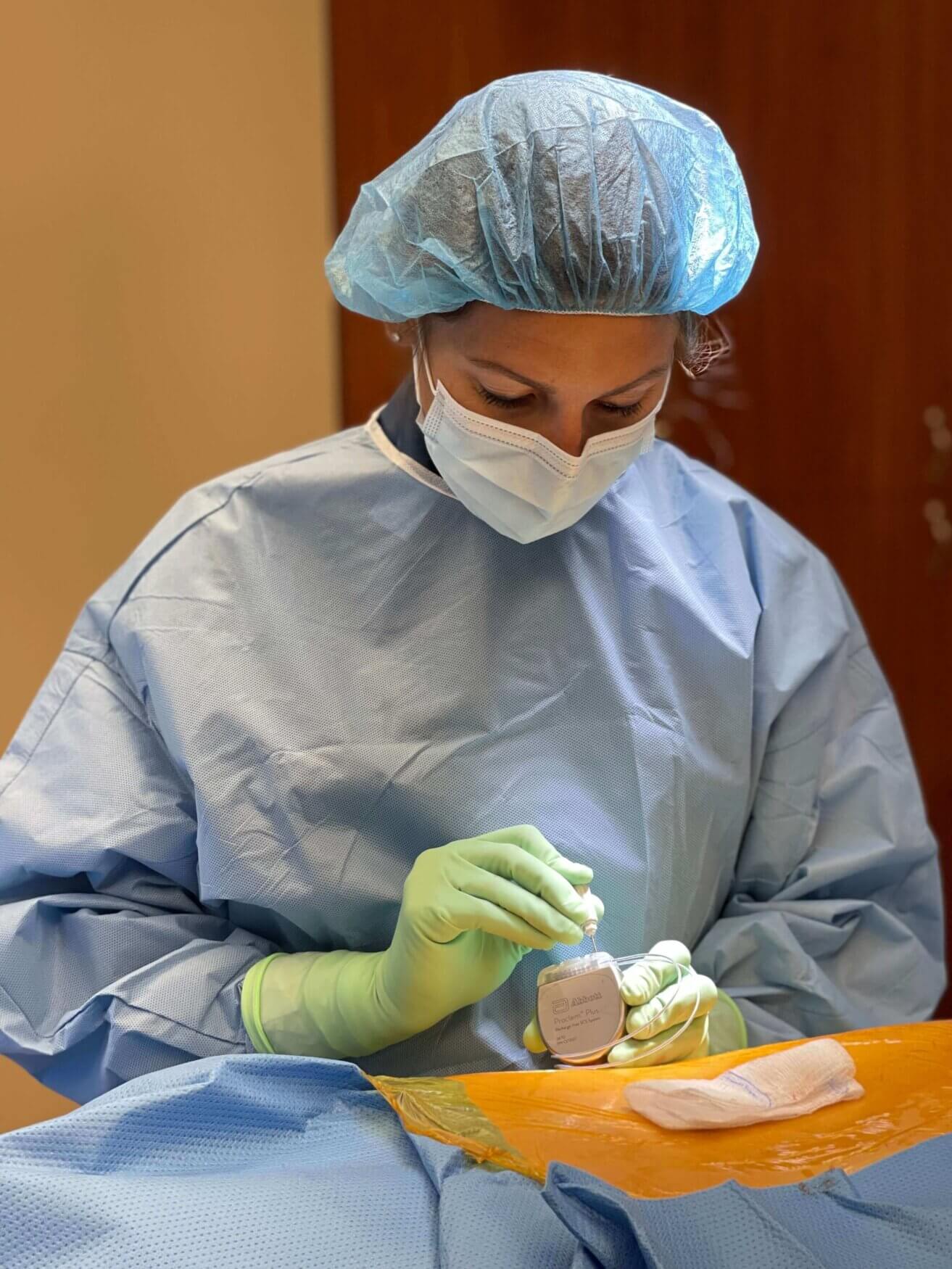 Dr. Sherri Haas of Twin Cities Pain Clinic in full surgical gear performing a spinal cord stimulator implant procedure