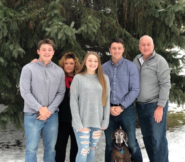 Twin Cities Pain Clinic patient Jayson Rogers posing with his family in winter