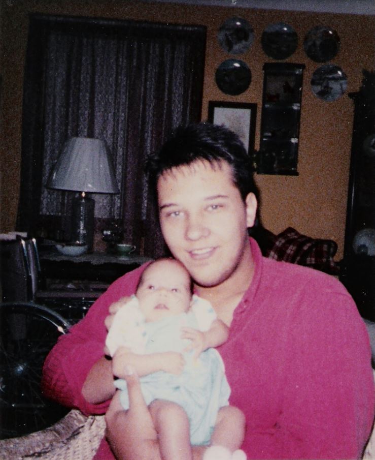 Frank holding his daughter before chronic pain started