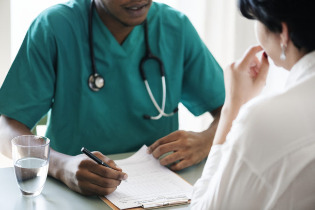 Doctor meeting with patient and taking notes