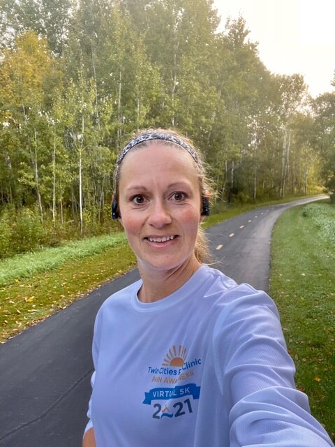 Twin Cities Pain Clinic employee taking selfie on outdoor running trail