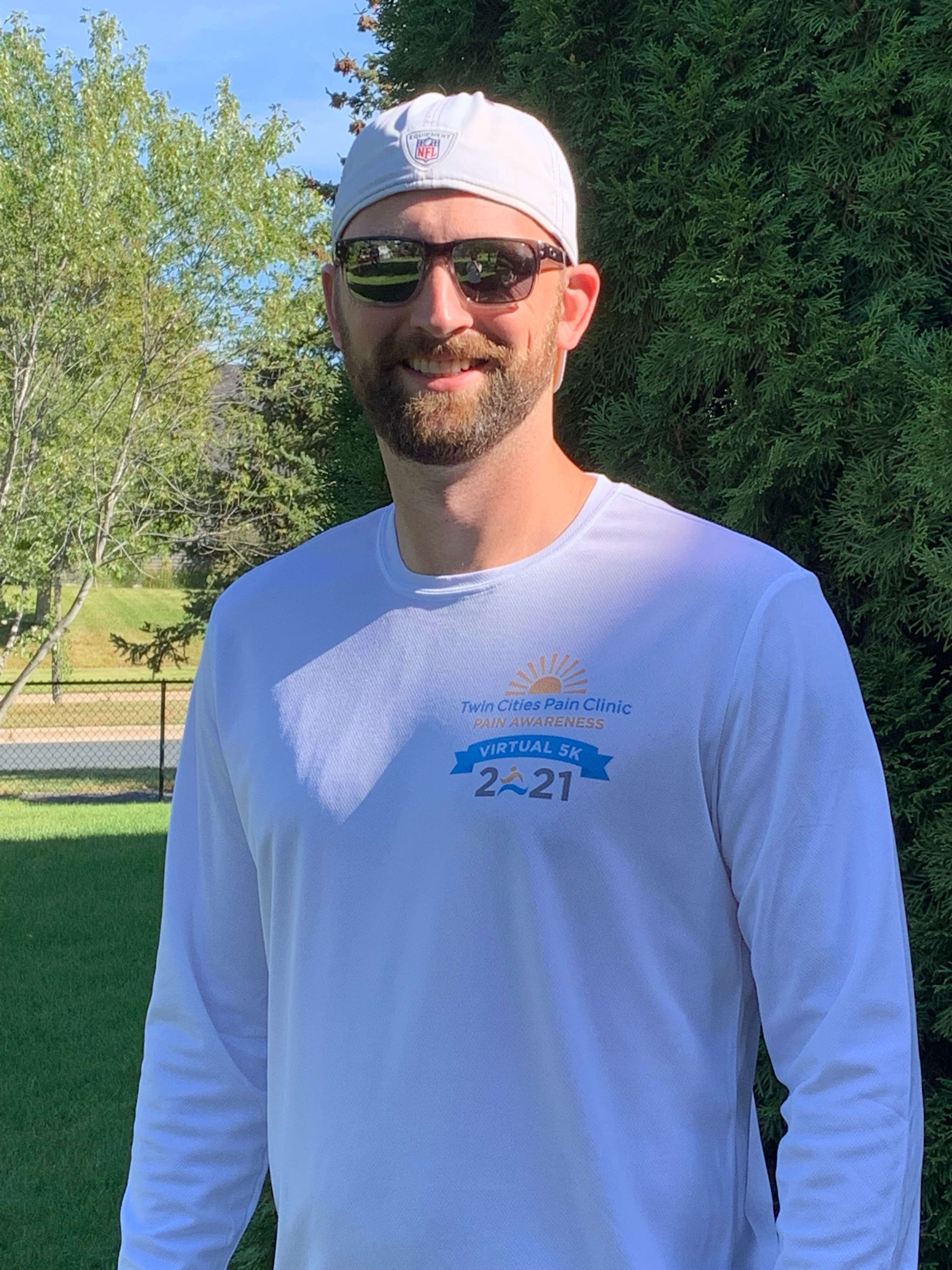 Twin Cities Pain Clinic employee with hat and sunglasses