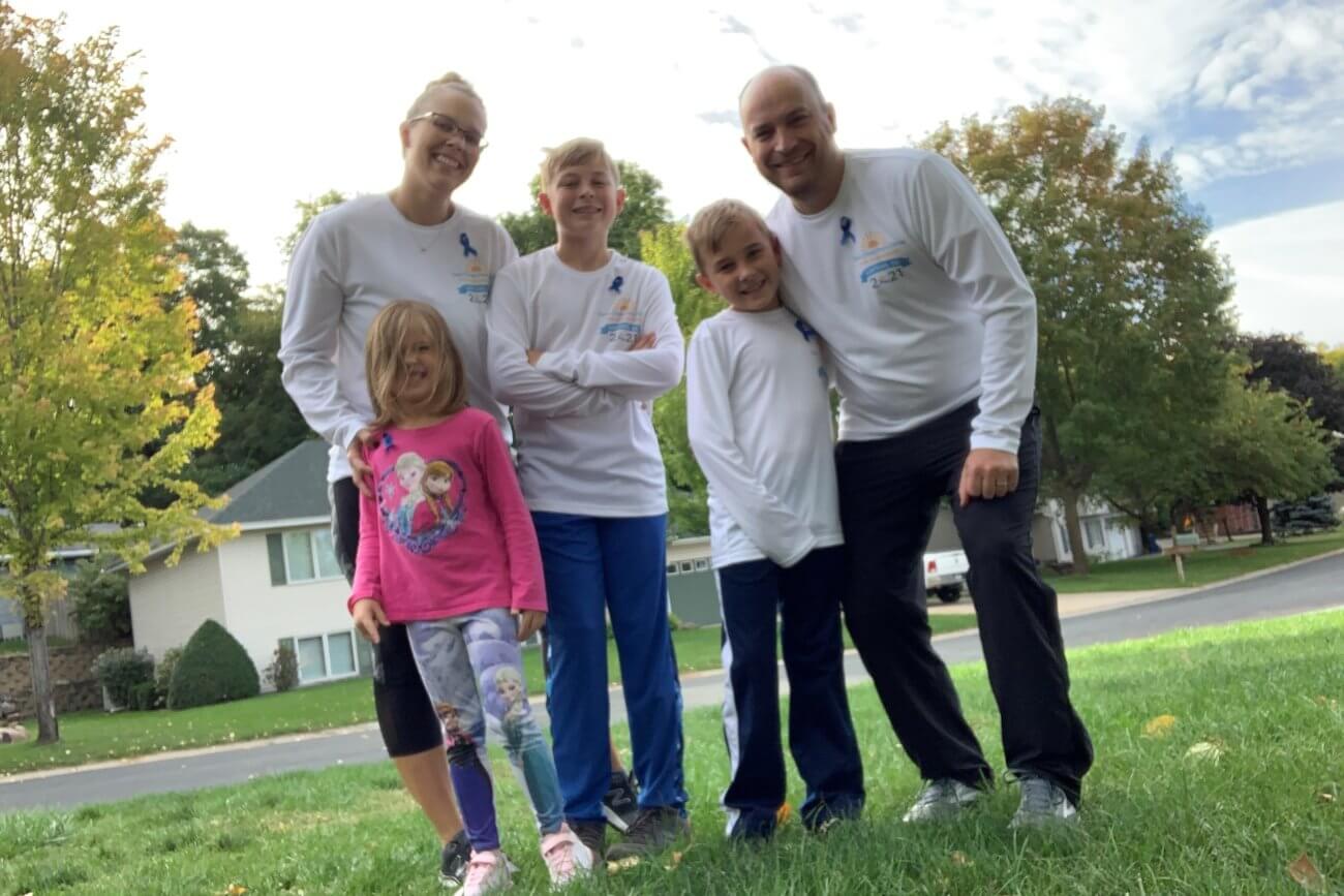 Twin Cities Pain Clinic employee and family posting before running race