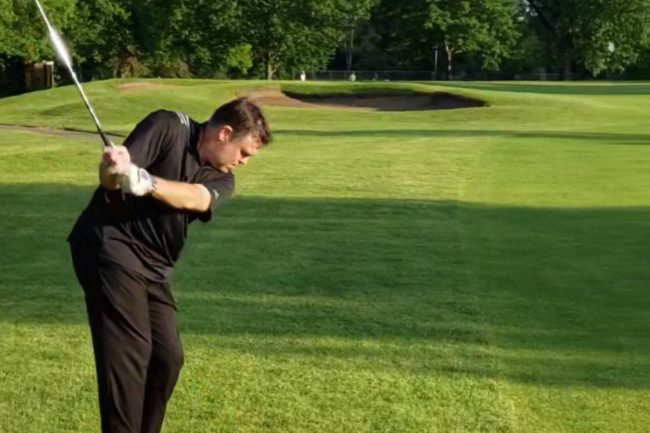 Spinal cord stimulation patient John Quinn making a golf shot