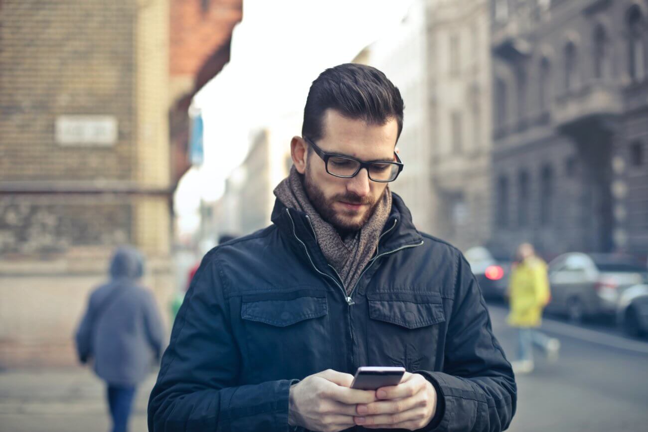 Man looking down at cell phone