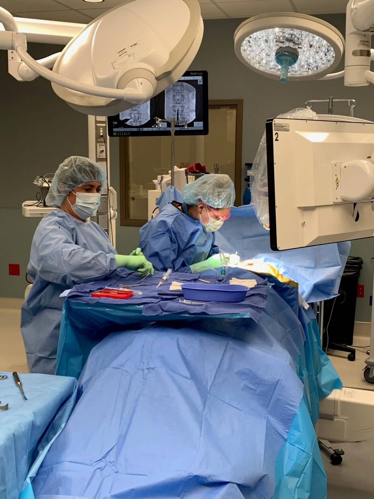 Surgical team in the operating room implanting the Eterna spinal cord stimulator by Abbott