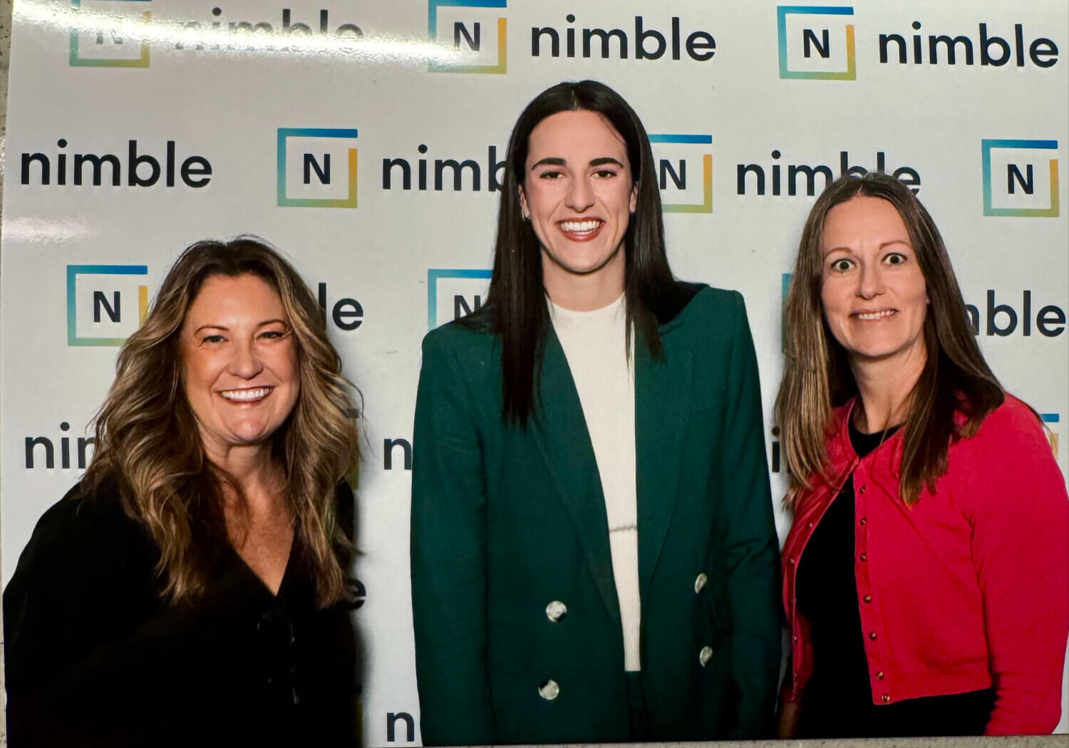 Twin Cities Pain Clinic employees Sheila Thompson and Brandy Kramer posing for a photo with Caitlin Clark